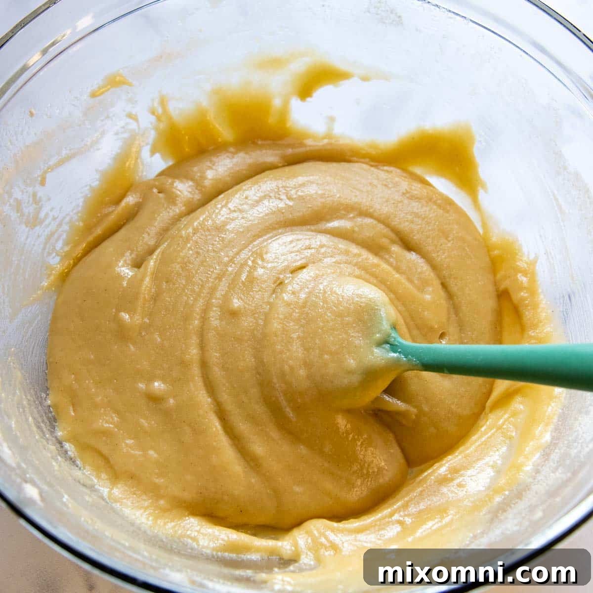 The smooth, light pizzelle batter resting in a mixing bowl, ready for the iron.