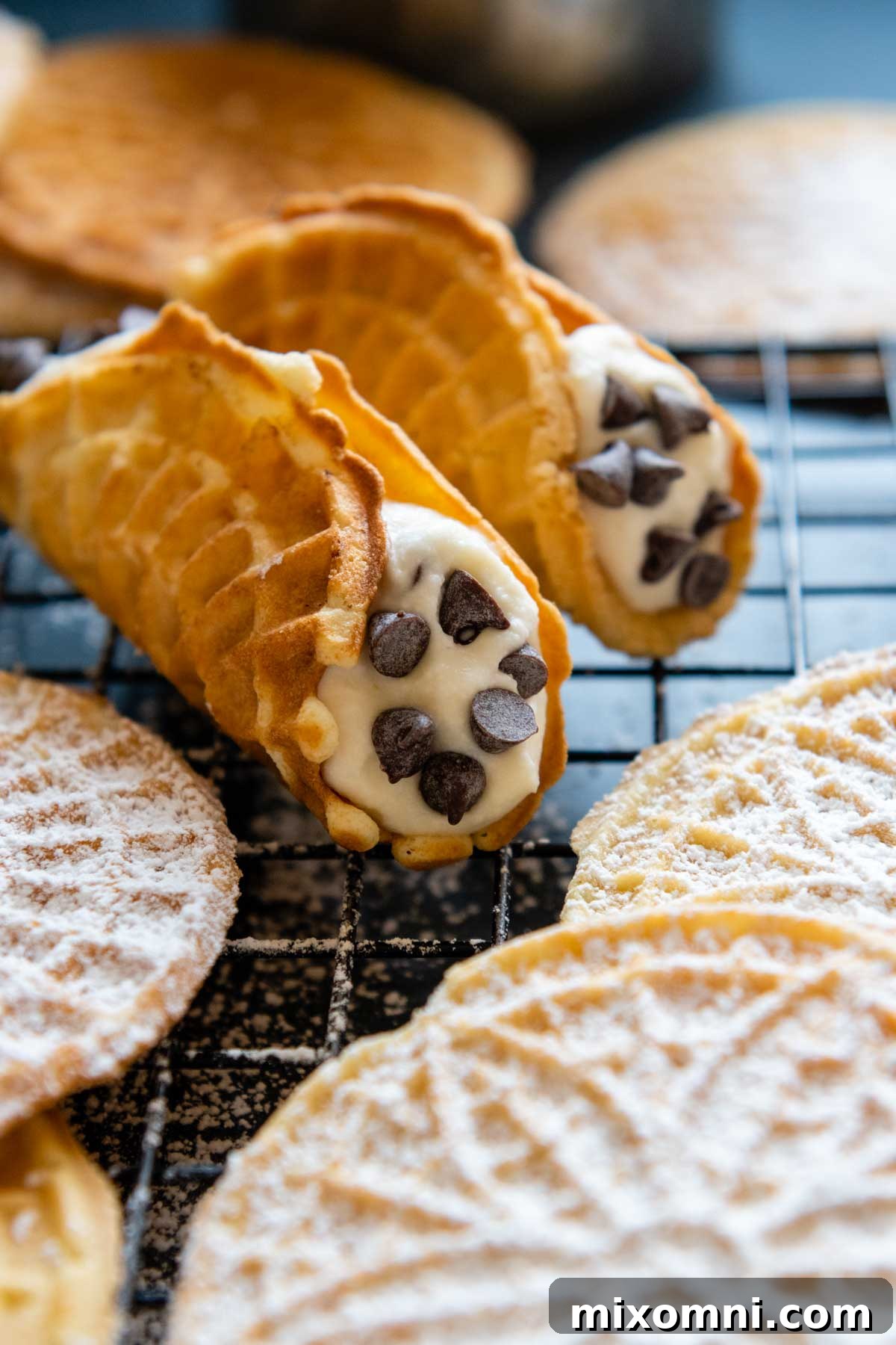 An inviting image of gluten-free pizzelles beautifully shaped into cannoli shells, ready for filling.