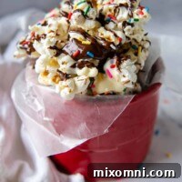 Close-up of chocolate popcorn with sprinkles, ready to eat.