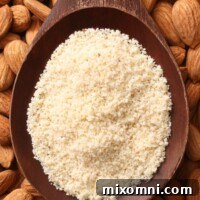 A wooden spoon filled with homemade almond flour.