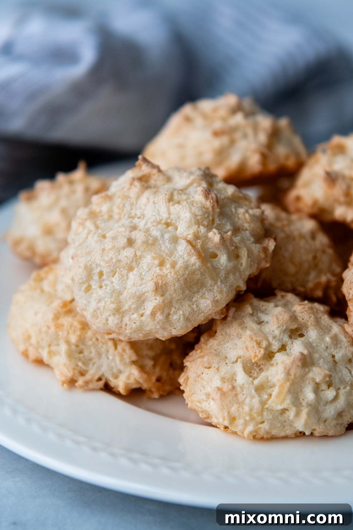macaroons piled onto a white plate.