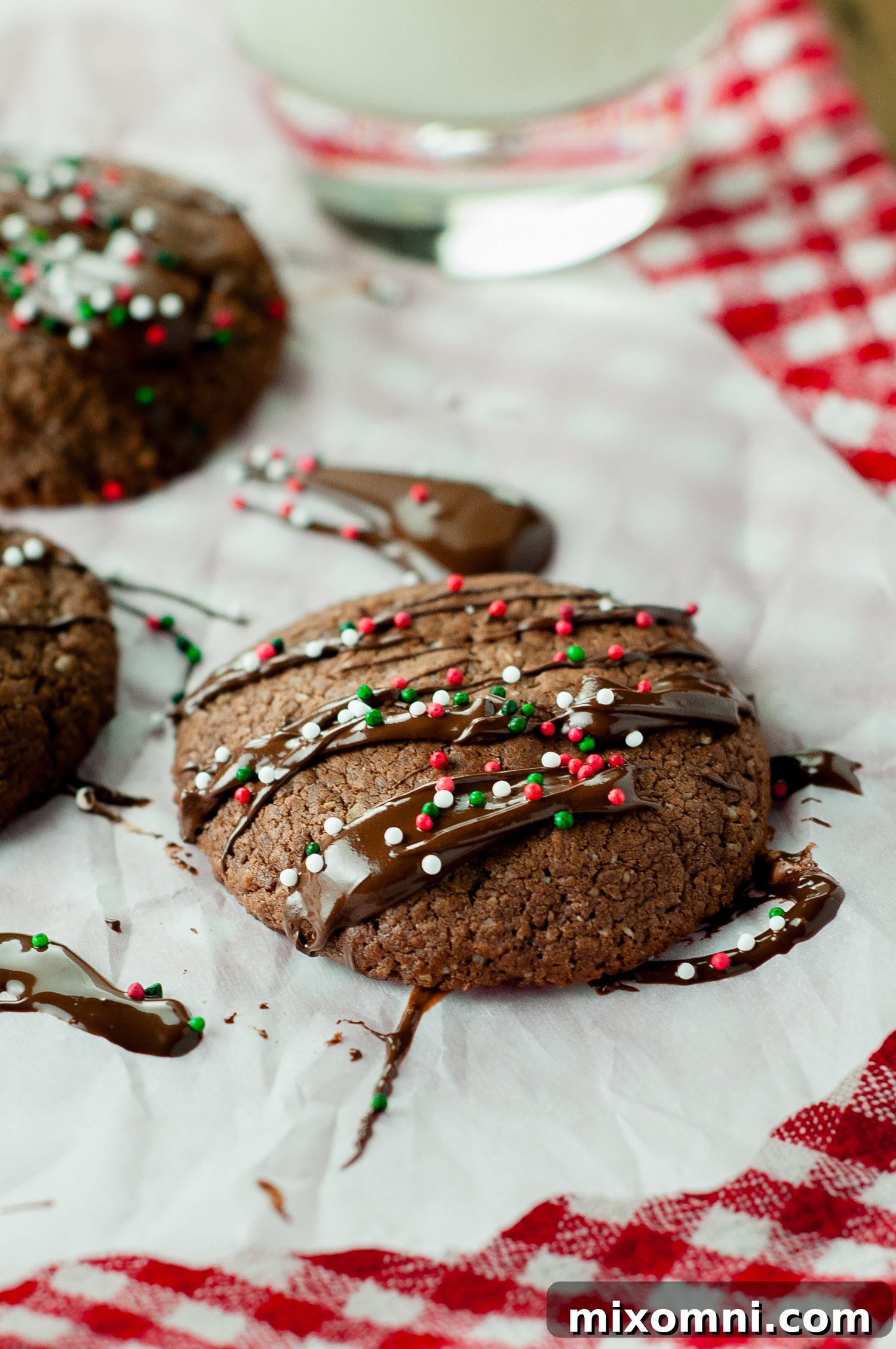 A Nutella cookie decorated with chocolate drizzle and colorful sprinkles, ready for the holidays.