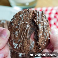 A Nutella cookie being split apart, showing its soft interior.