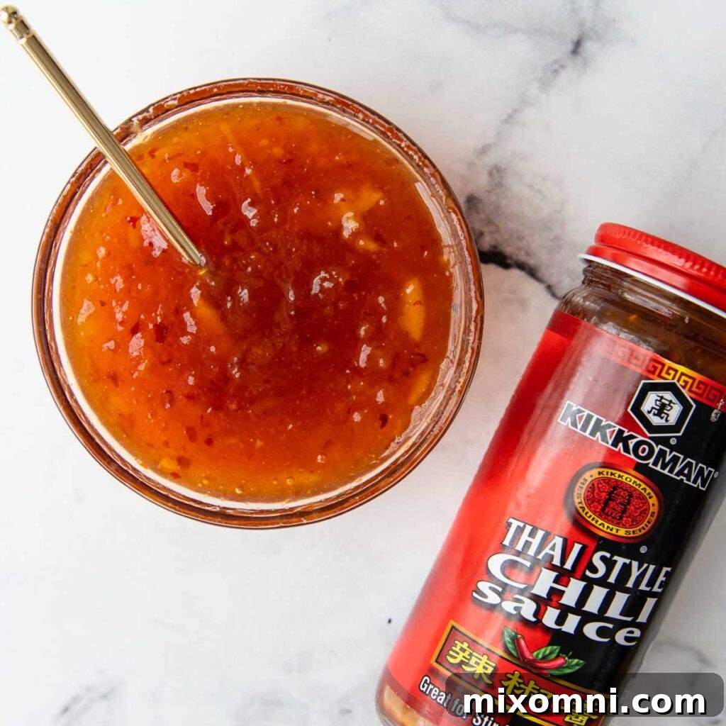 A vibrant, golden dipping sauce for shrimp served in a small clear glass bowl, showcasing its smooth texture and appealing color.