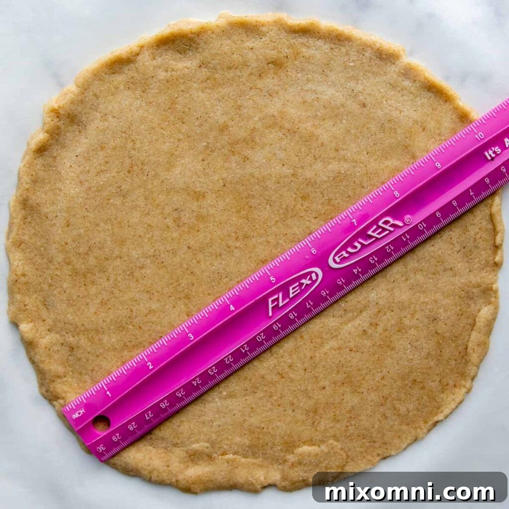 A ruler demonstrating the 10-inch diameter of a perfectly rolled almond flour pizza crust.