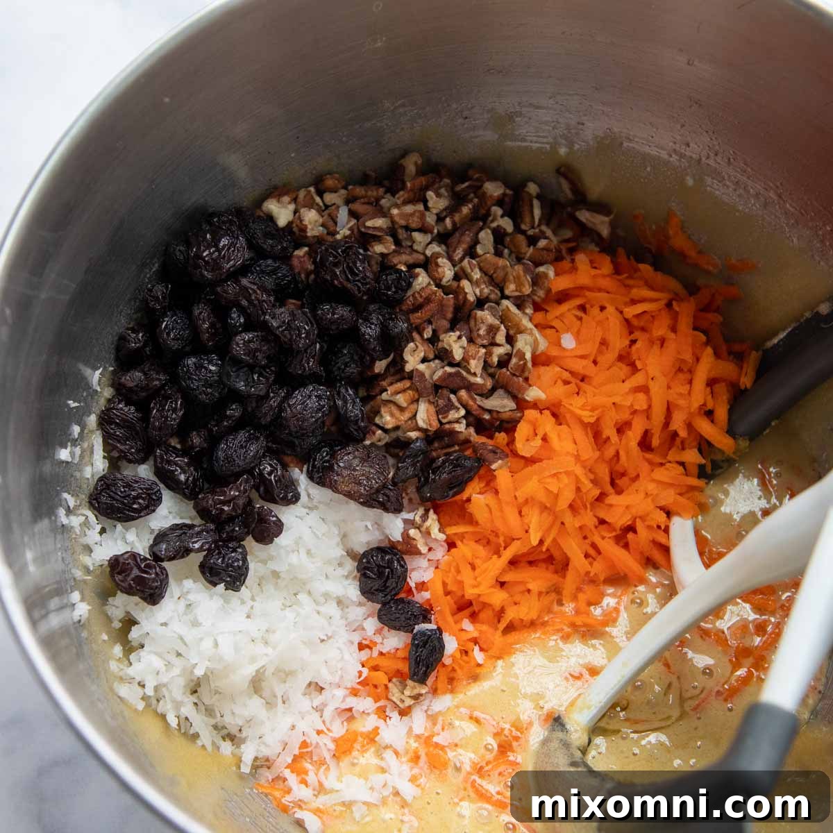 cake batter with carrots, nuts, and coconut added.