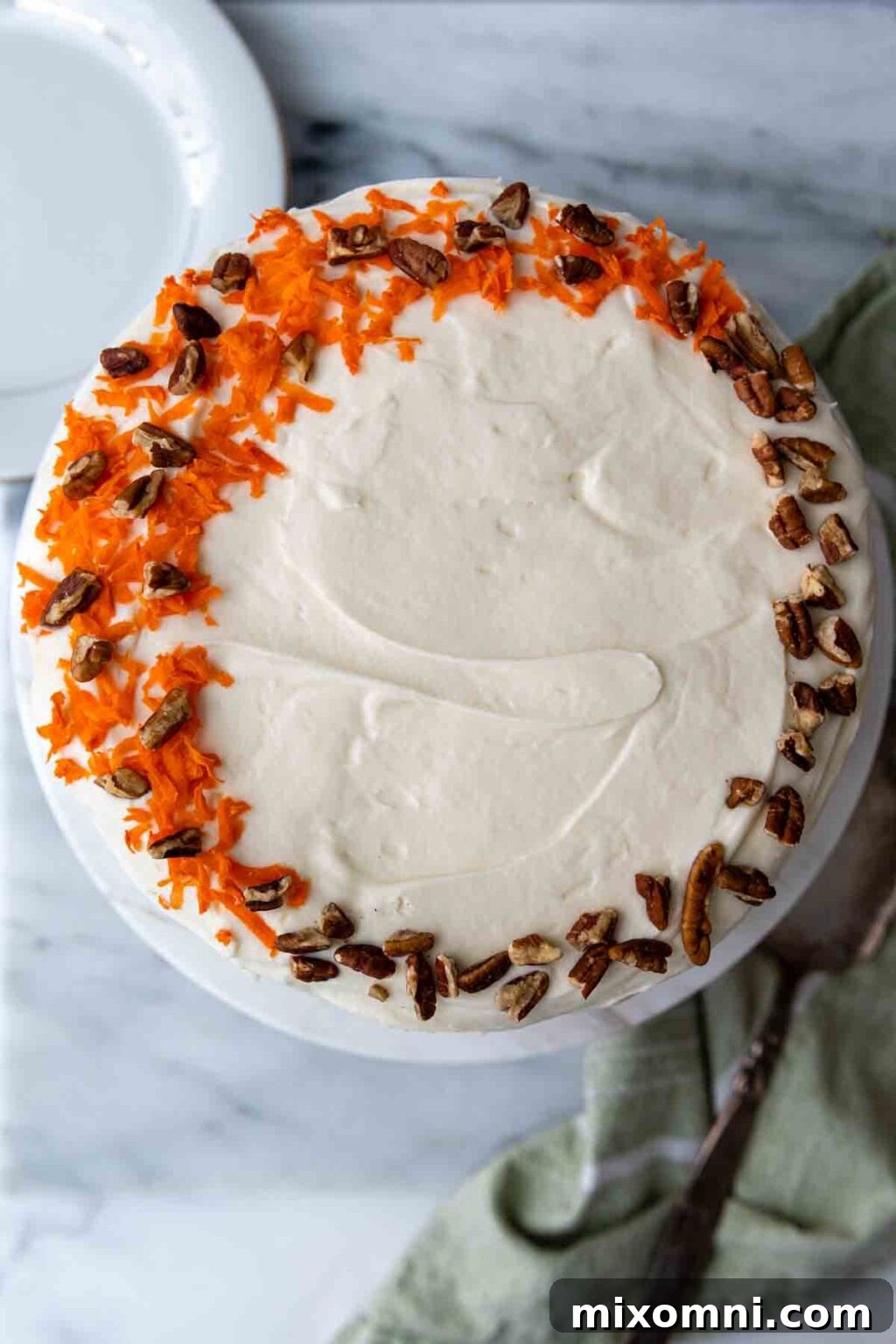top of cake with grated carrots and nuts.