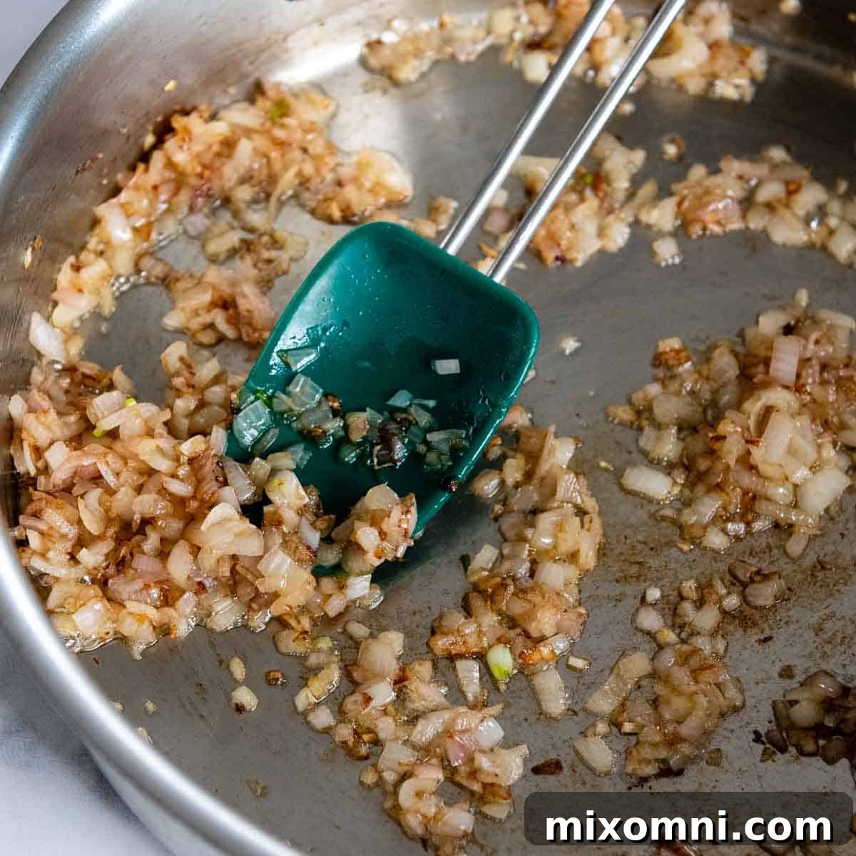 Minced shallots gently sautéing in melted butter in a deep oven-proof skillet.