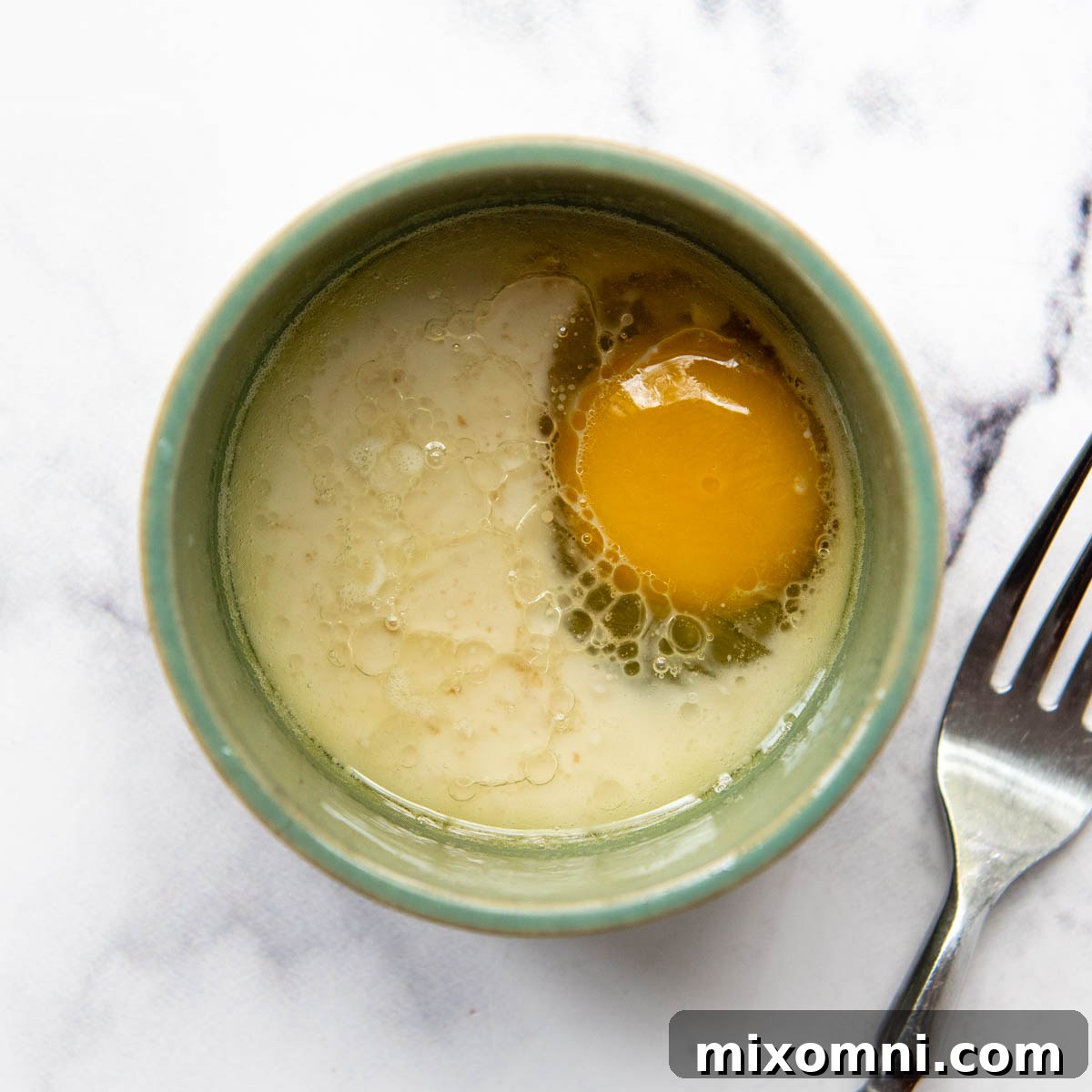 Liquid ingredients mixed in a mug to make the oat mug cake.