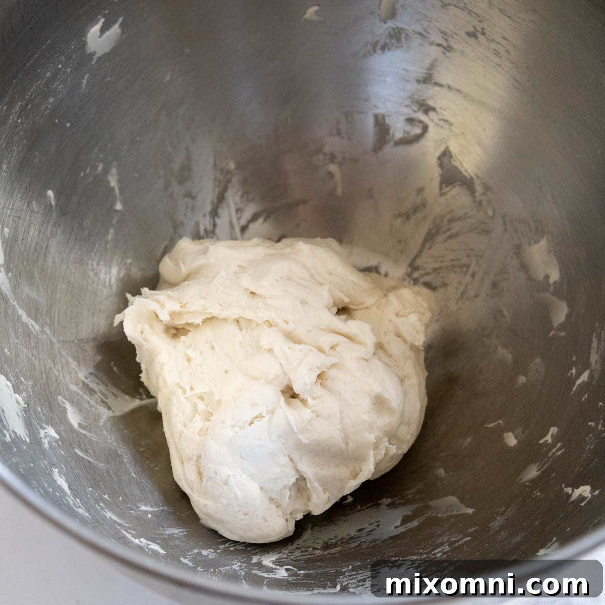 Gluten-free flatbread dough before rising, a compact mass in a bowl.