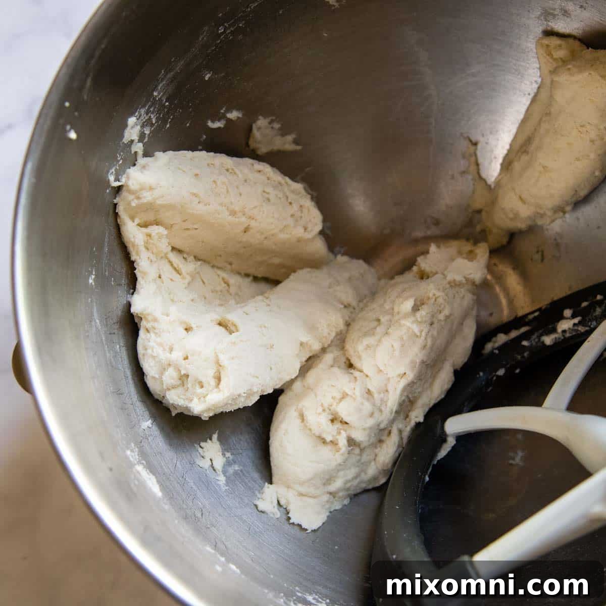 The perfectly mixed gluten-free tortilla dough, smooth and ready for its resting period, indicating ideal consistency.