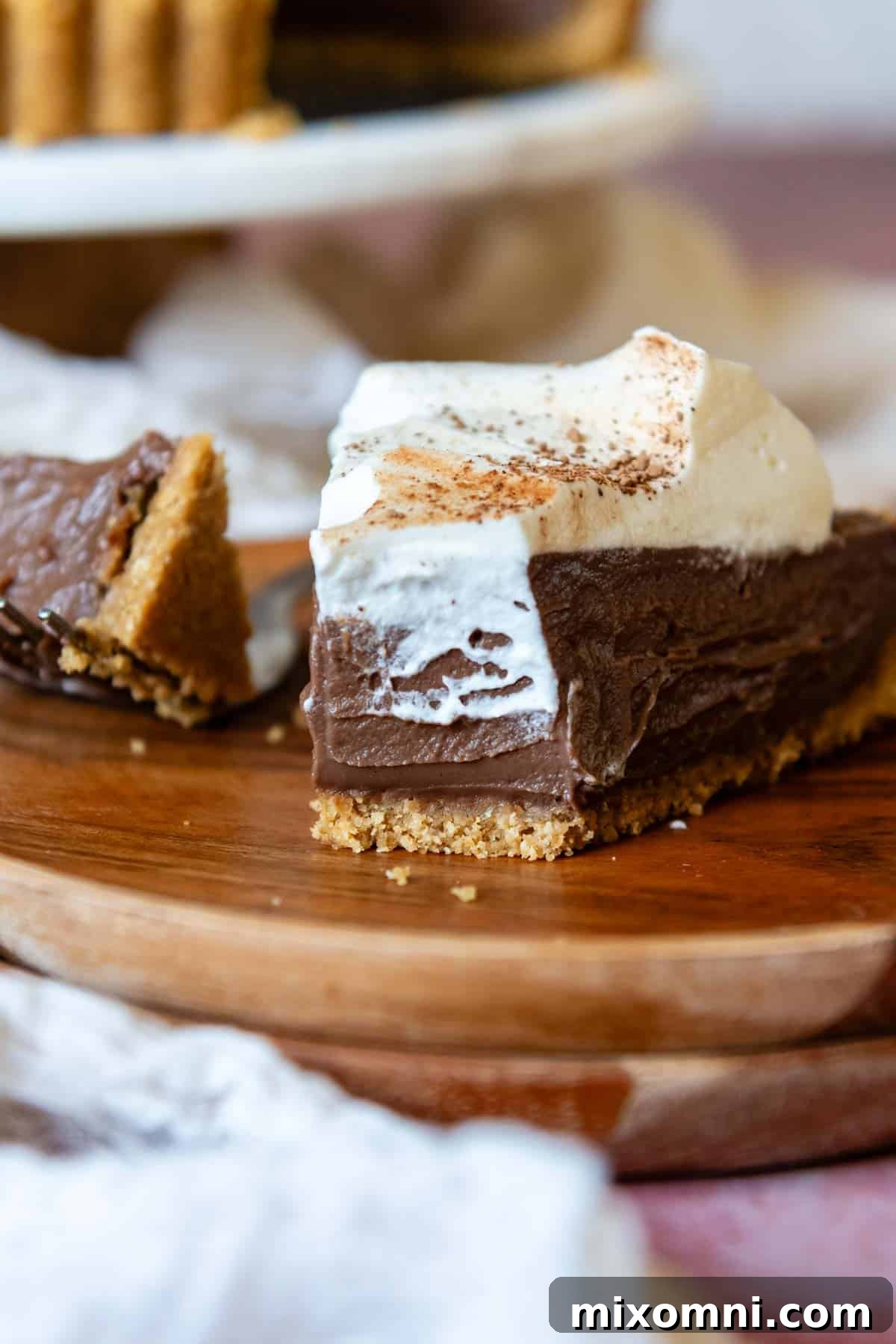 A close-up shot of a perfect bite of chocolate tart, showcasing the crisp and stable gluten-free graham cracker crust holding together beautifully.