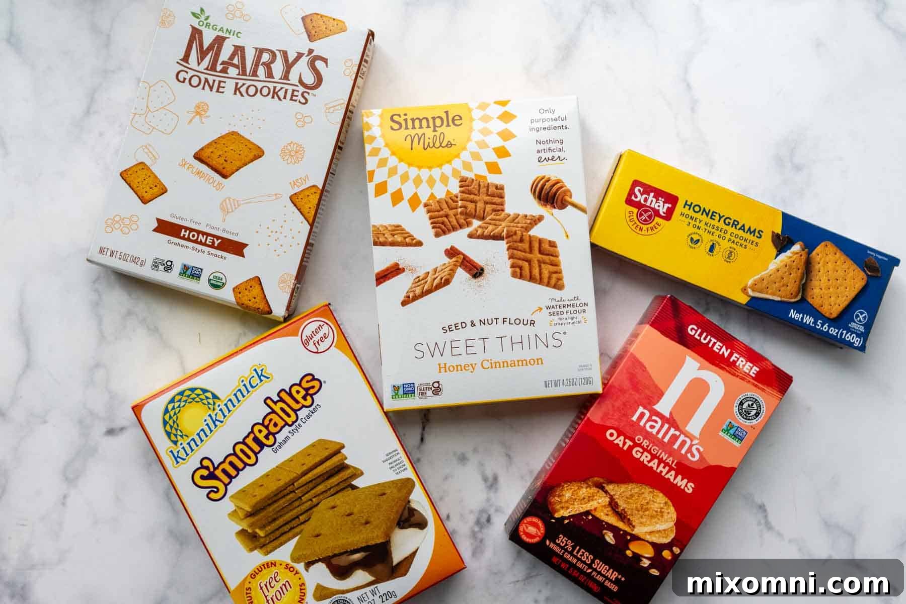 An assortment of different brands of gluten-free graham crackers displayed, highlighting the importance of choosing the right one for your crust.