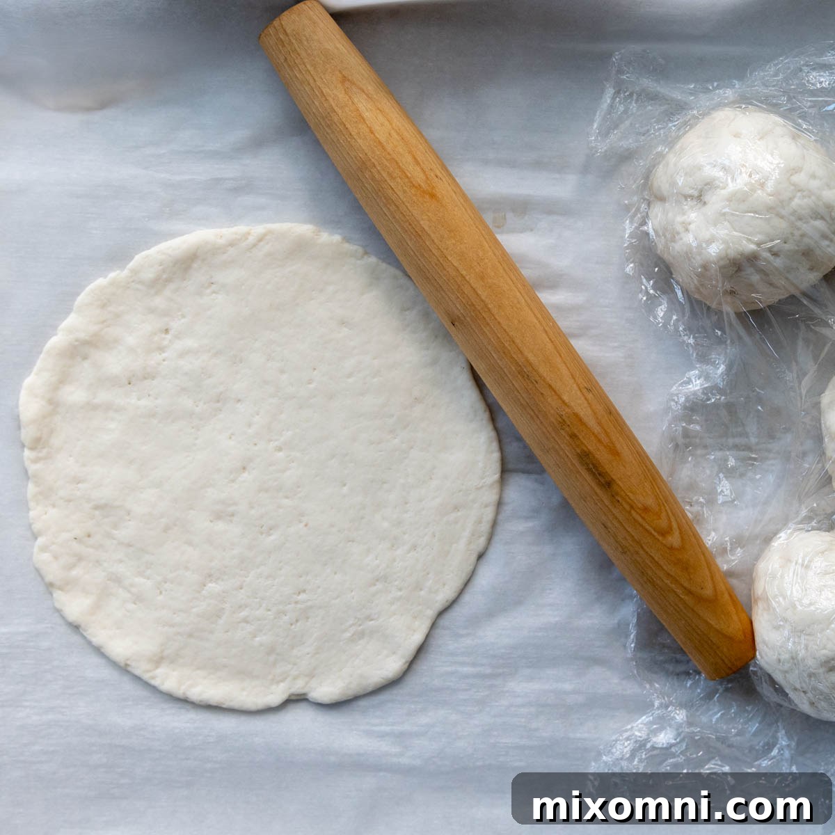 The gluten-free flatbread dough rolled out into a circle.