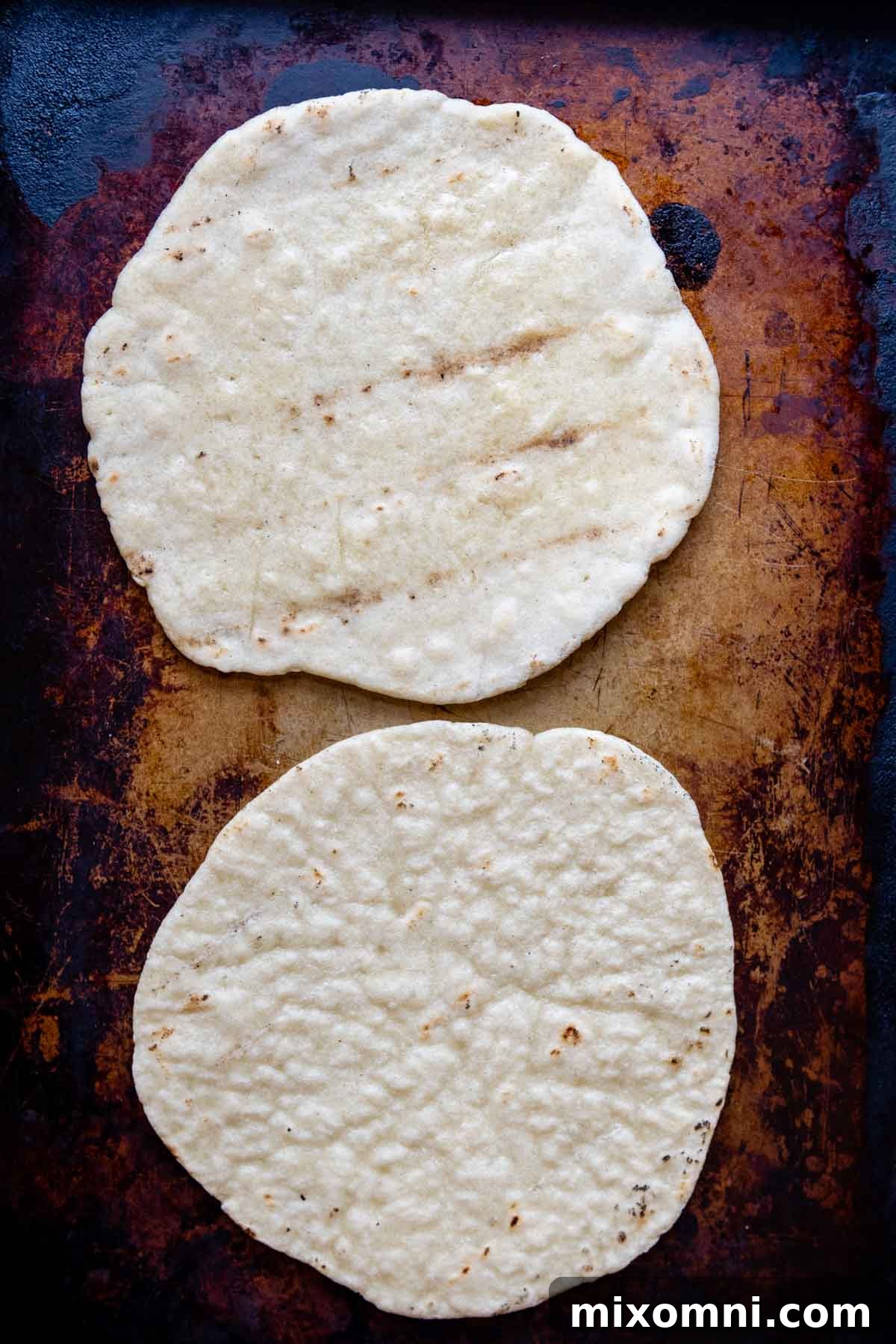 Slightly grilled pizza crusts ready for toppings.