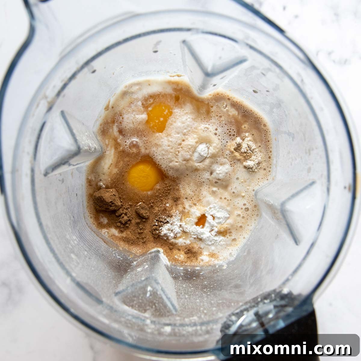 All oat flour pancake ingredients added to a blender, ready to be combined.