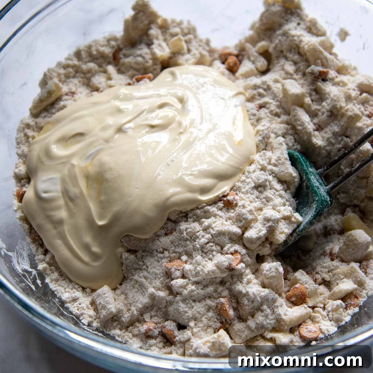 Wet ingredients (sour cream, egg yolk, vanilla) being whisked together before adding to dry mix.