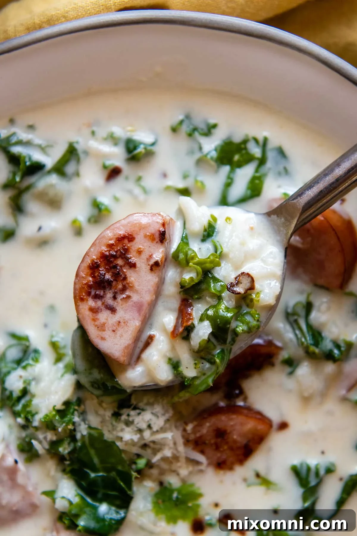 a spoon lifting out a bite of soup.