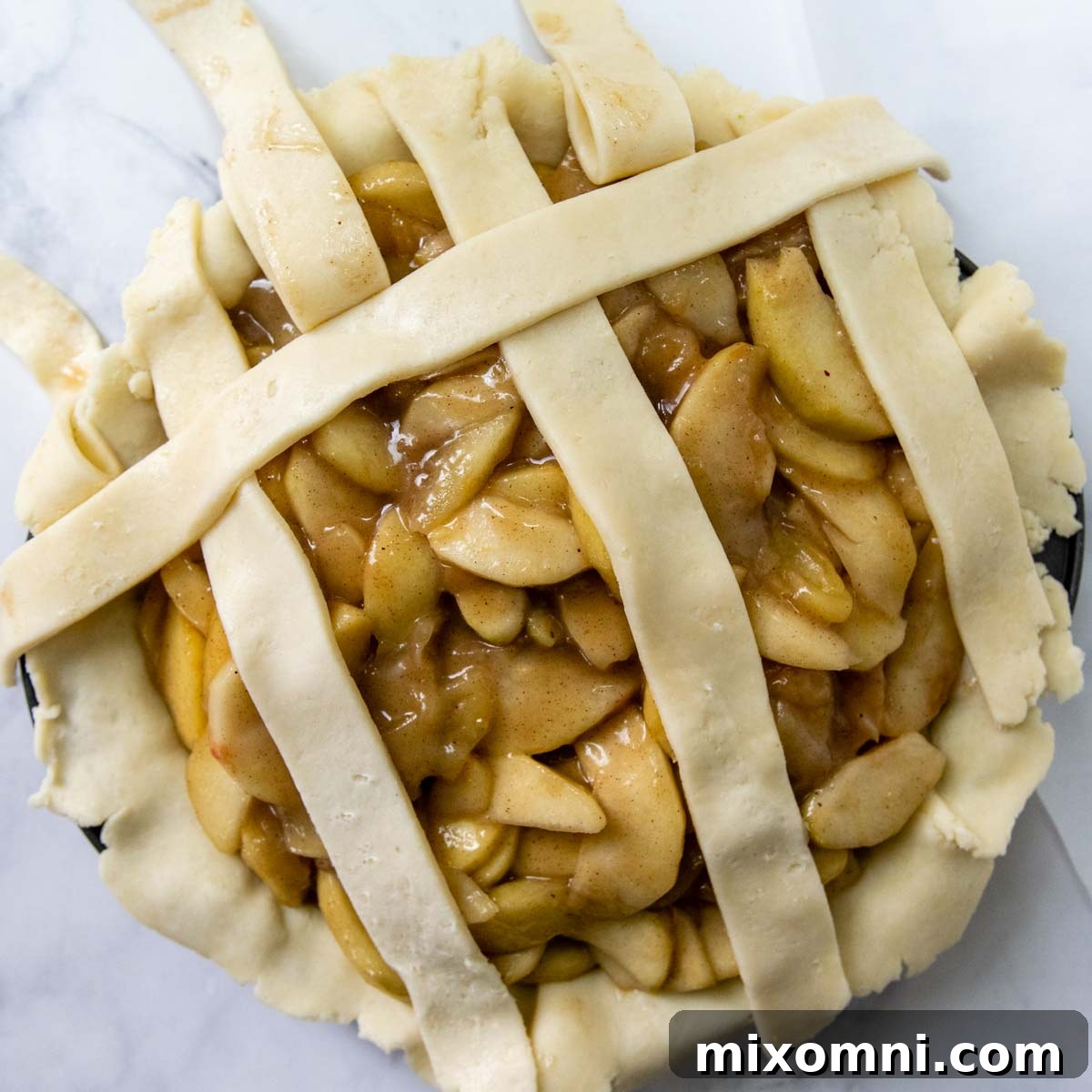 A lattice crust being formed, showing alternating strips folded back to weave a new strip.