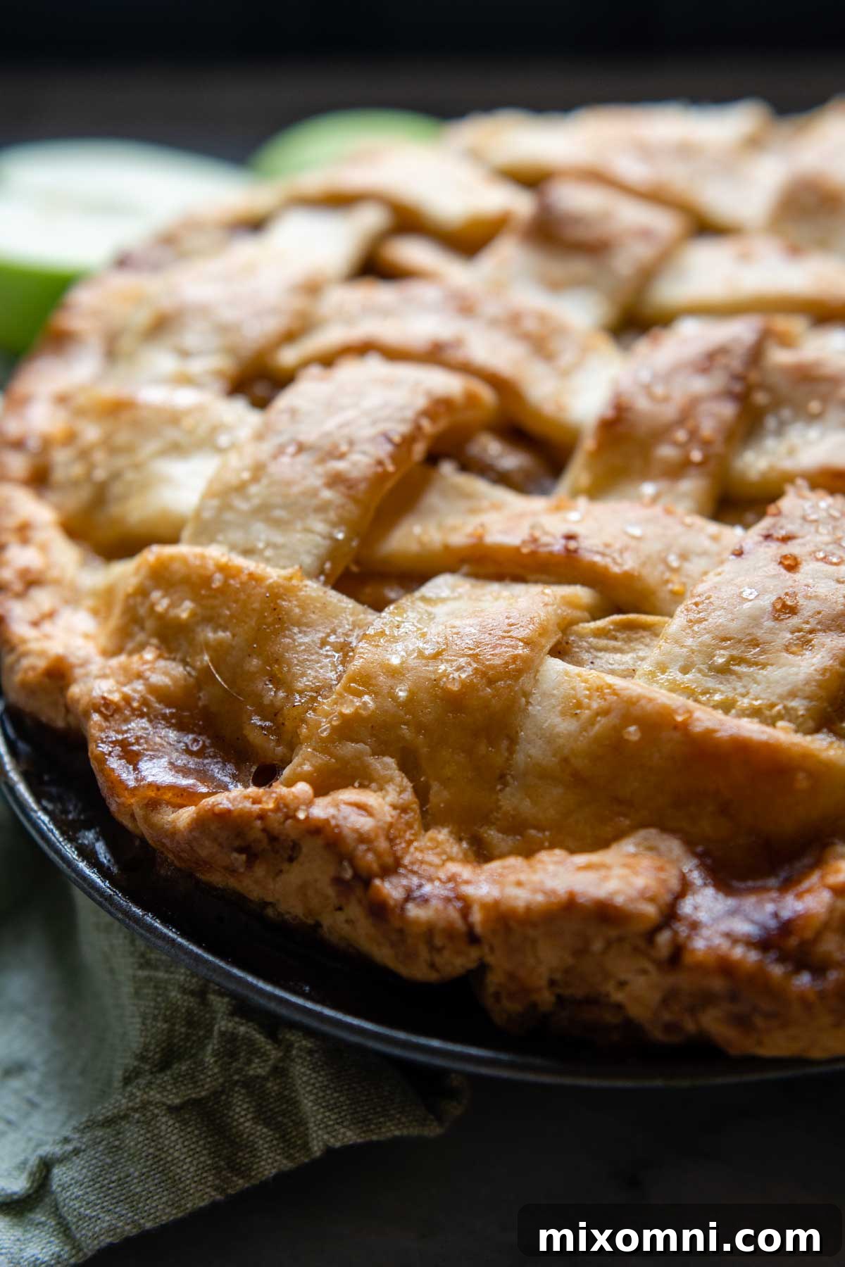 A close-up view of the intricate lattice crust on a baked apple pie, showcasing its golden-brown perfection.