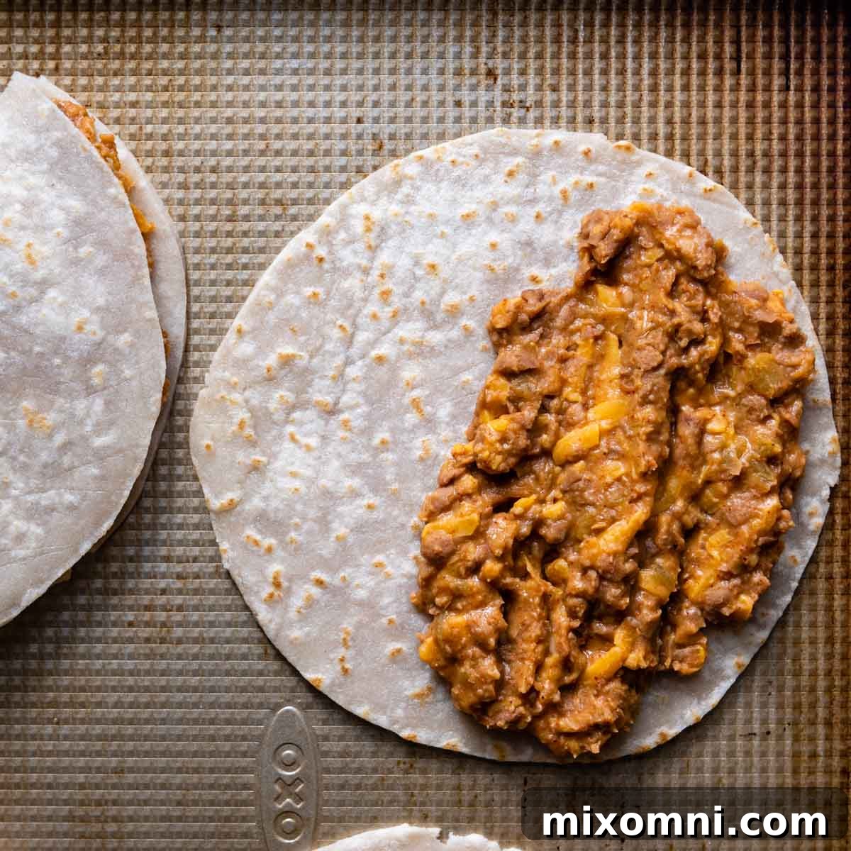 half the tortilla spread with bean mixture.