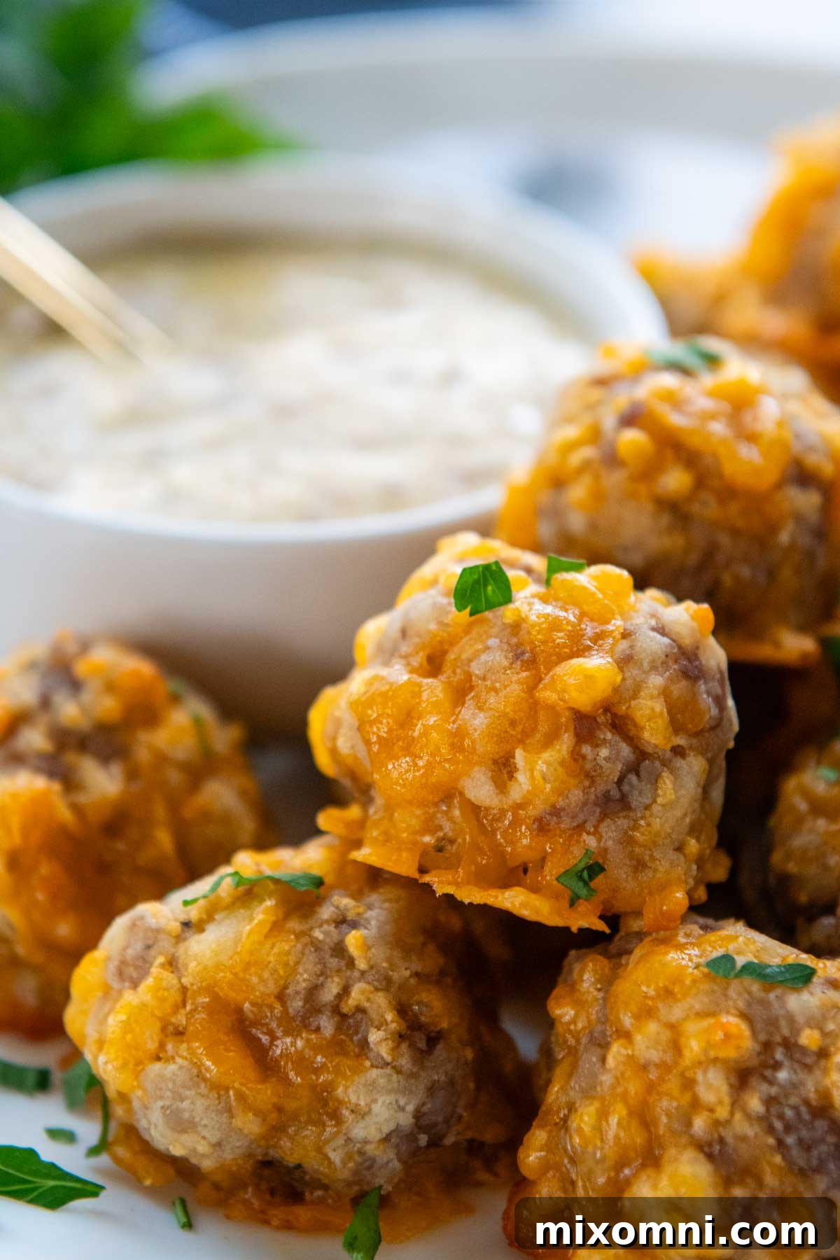 a close up of sausage balls piled up on a plate.