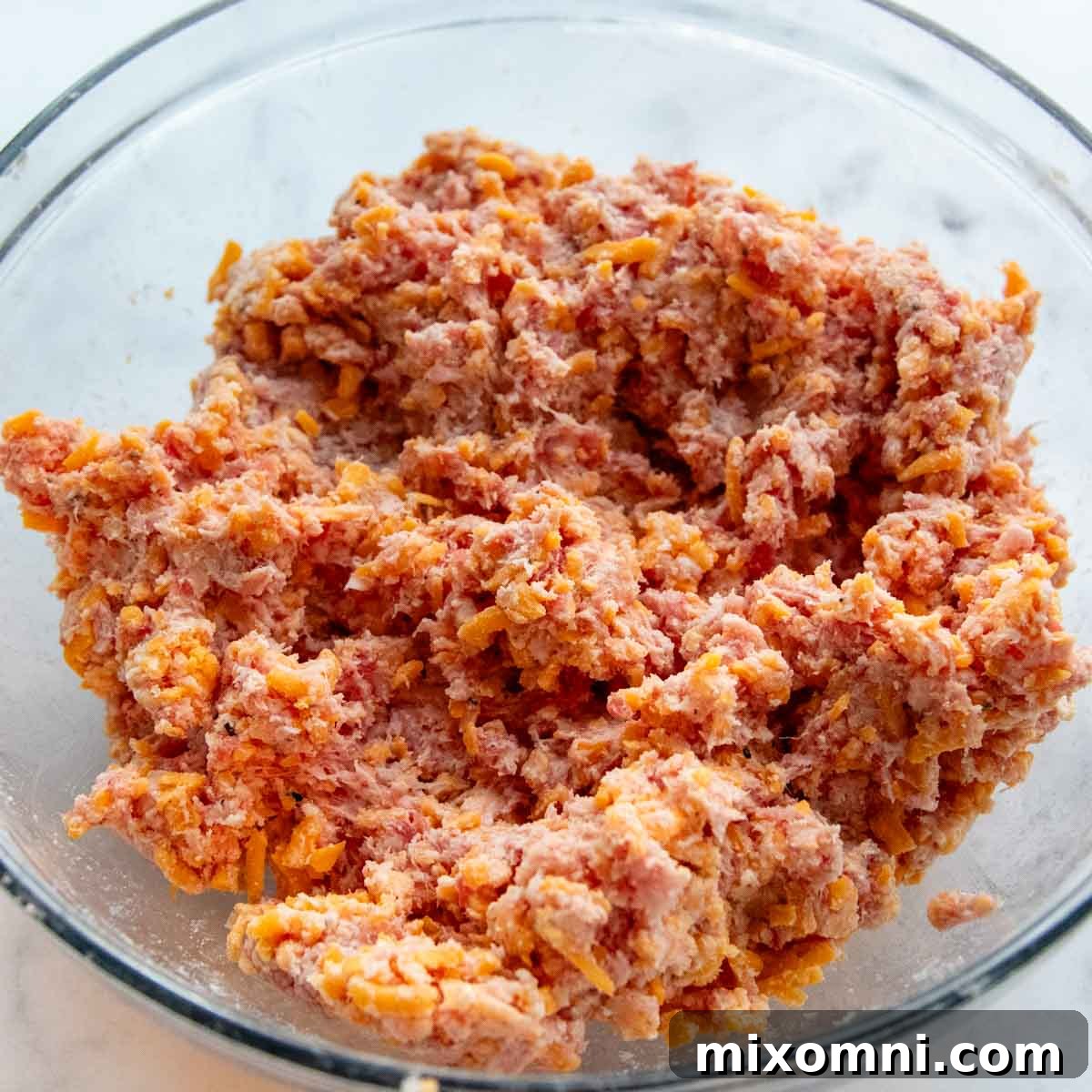 ground sausage mixture in a glass bowl.