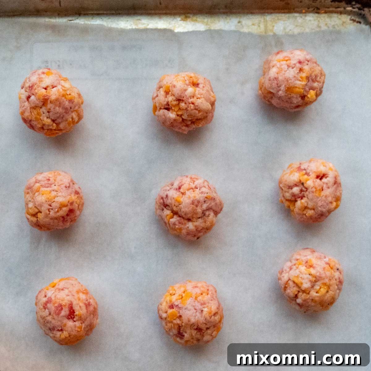 The balls shaped on a baking sheet.