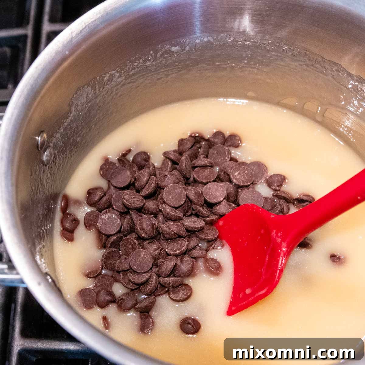 chocolate chips being stirred into milk mixture.
