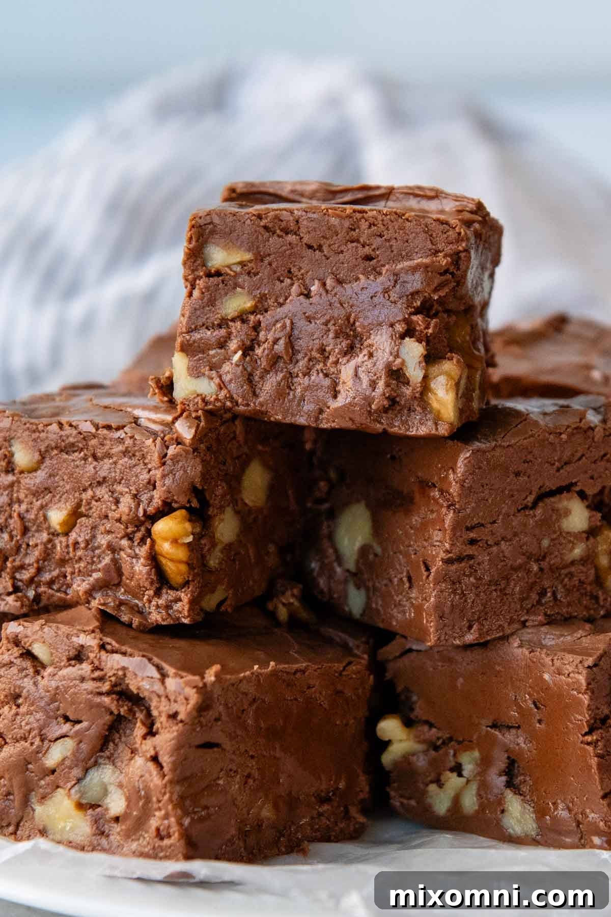 a stack of chocolate fudge with nuts inside.