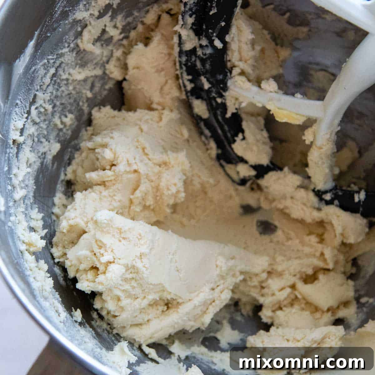 Close-up of the gluten-free shortbread dough after mixing with flour, showing its stiff and uniform texture ready for shaping.