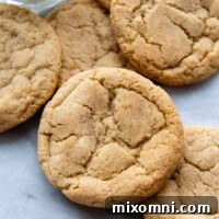 snickerdoodles arranged on a marble surface with a glass of milk.