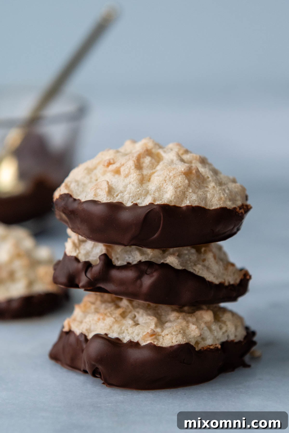 stack of three cookies with the bottom dipped in chocolate.