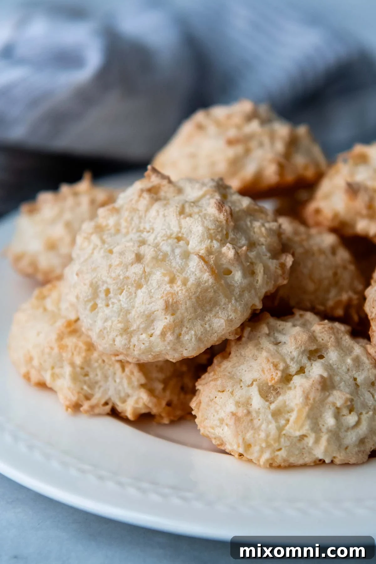 macaroons piled onto a white plate.
