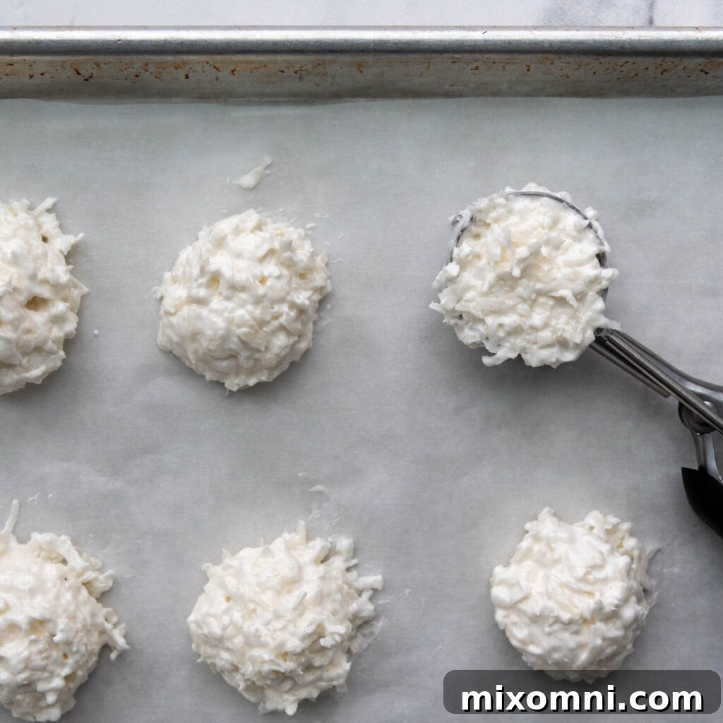 unbaked macaroons on a baking sheet.