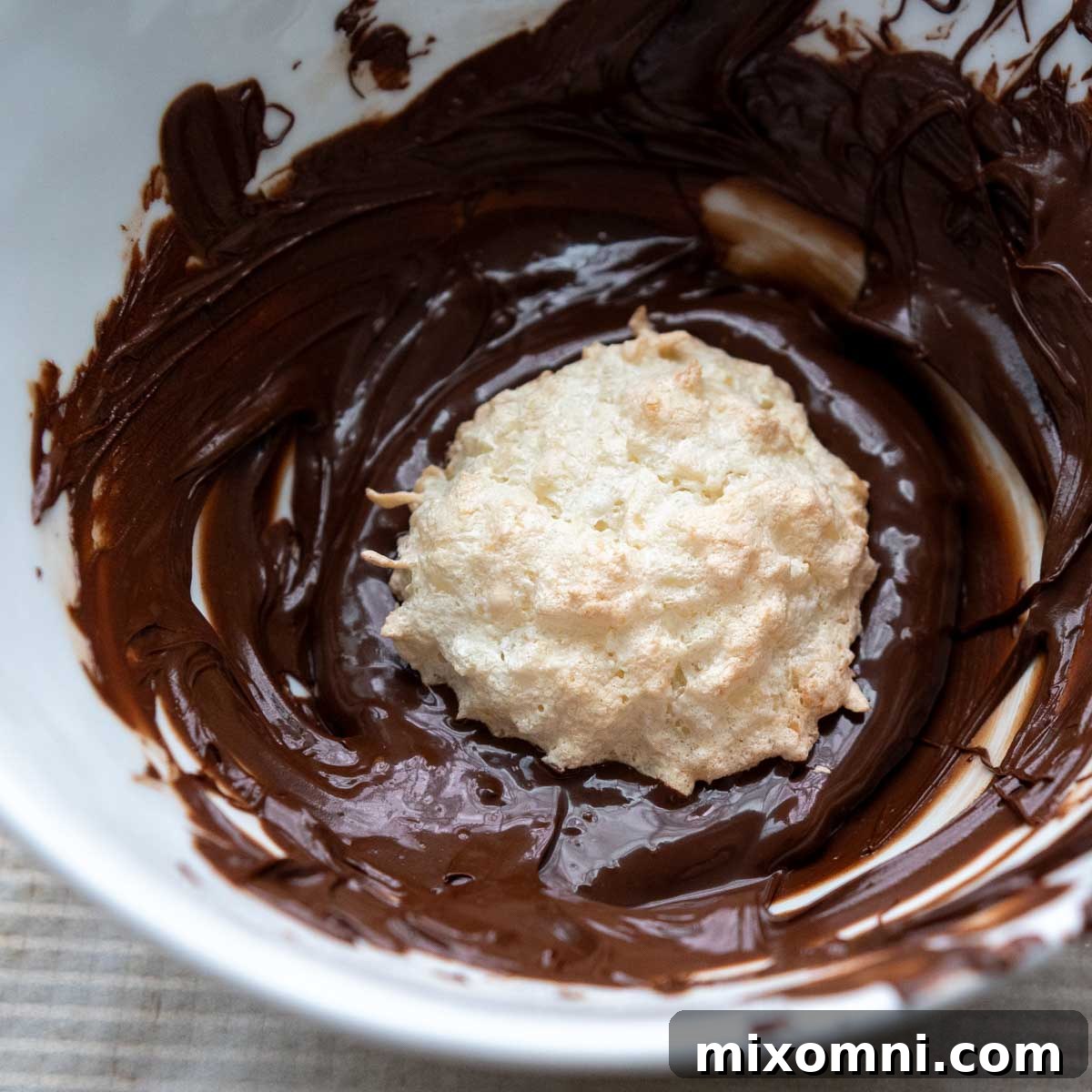macaroon in a bowl of chocolate.