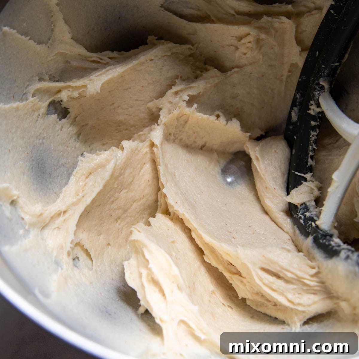 The mixed gluten-free dough in a stand mixer bowl, showing its stiff but sticky consistency.