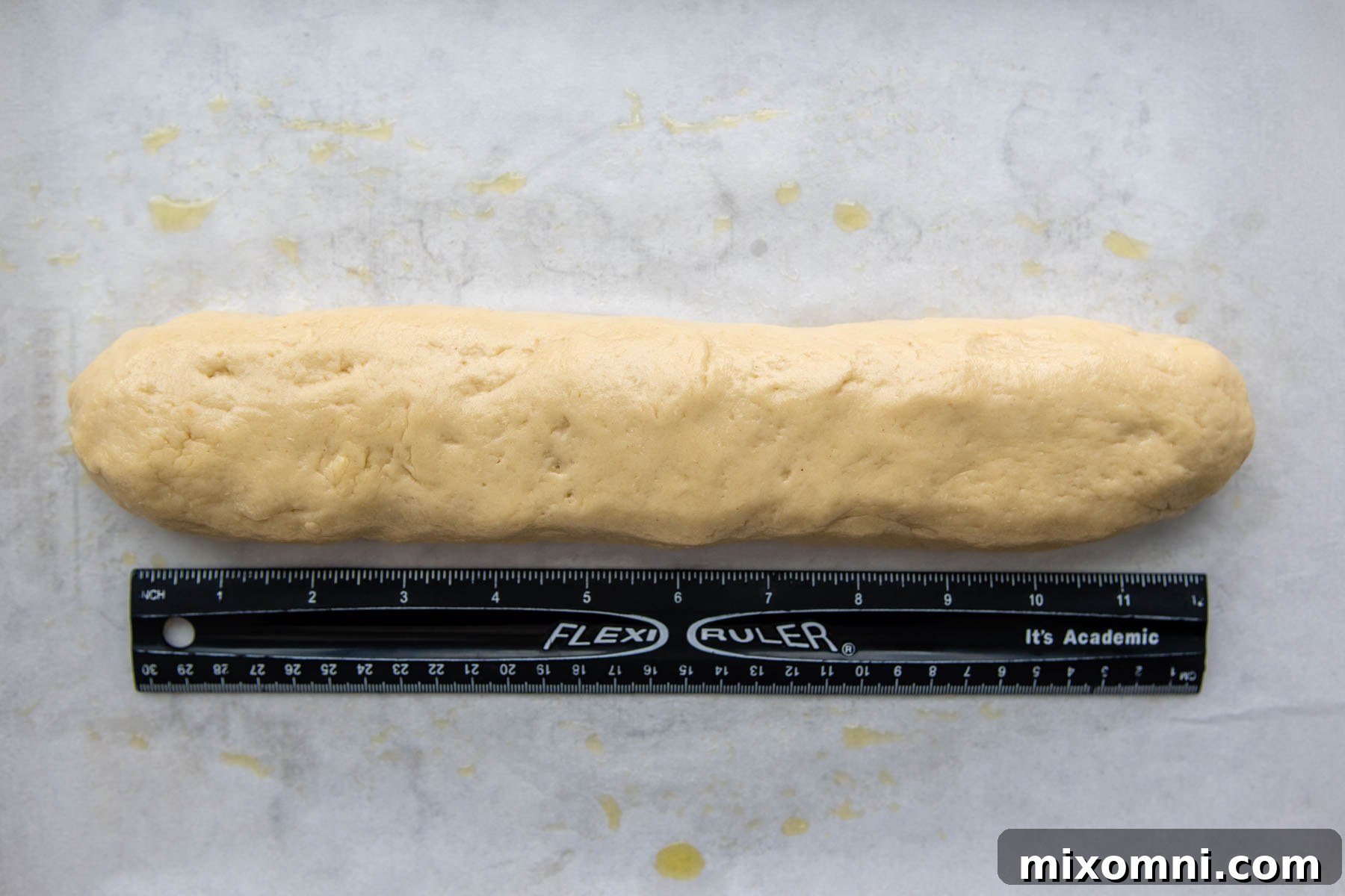 a ruler measuring the length of the shaped dough.
