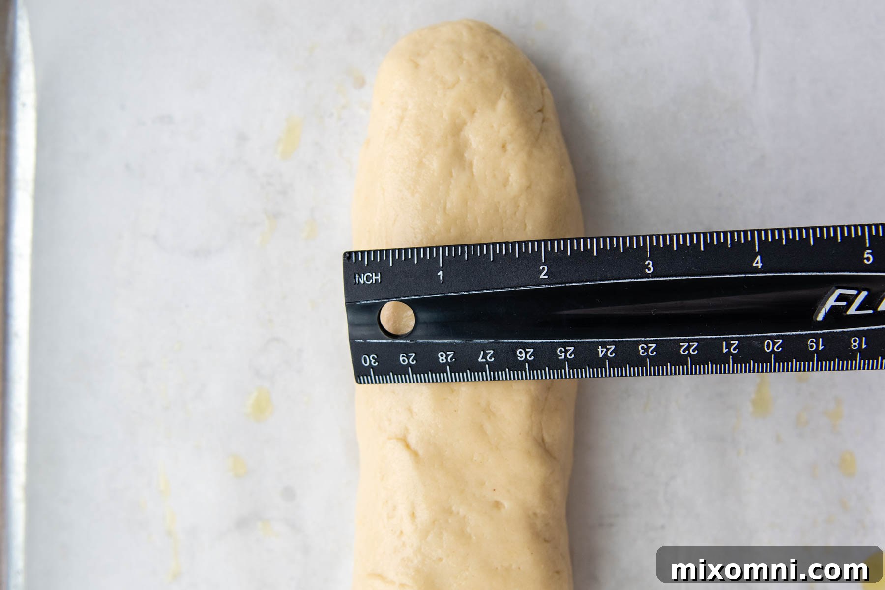 a ruler measuring the width of the shaped dough.