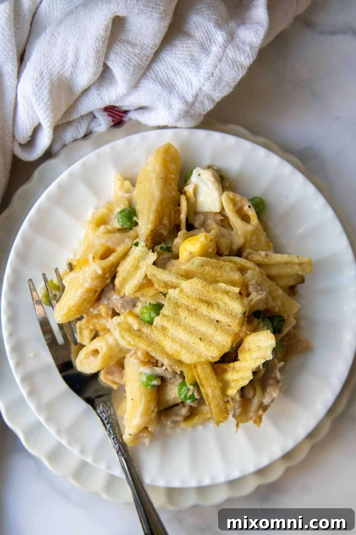 overhead shot of a serving of tuna casserole on a white plate