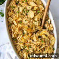 overhead shot of tuna casserole with a wooden spoon going into it