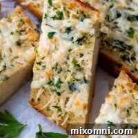 A slice of garlic bread resting on other slices, showcasing its inviting texture.