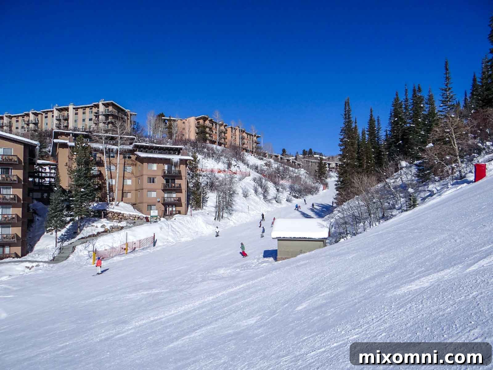 Lodge buildings nestled at the base of Steamboat Mountain, showcasing various accommodation options including hotels and condos with convenient ski access.