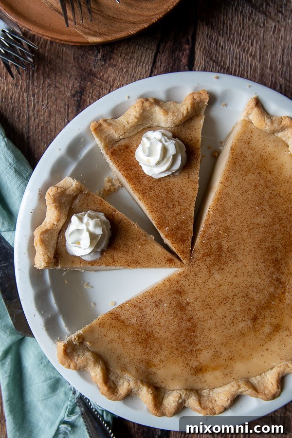 overhead shot of hoosier pie with a couple slices cut and whipped cream on top