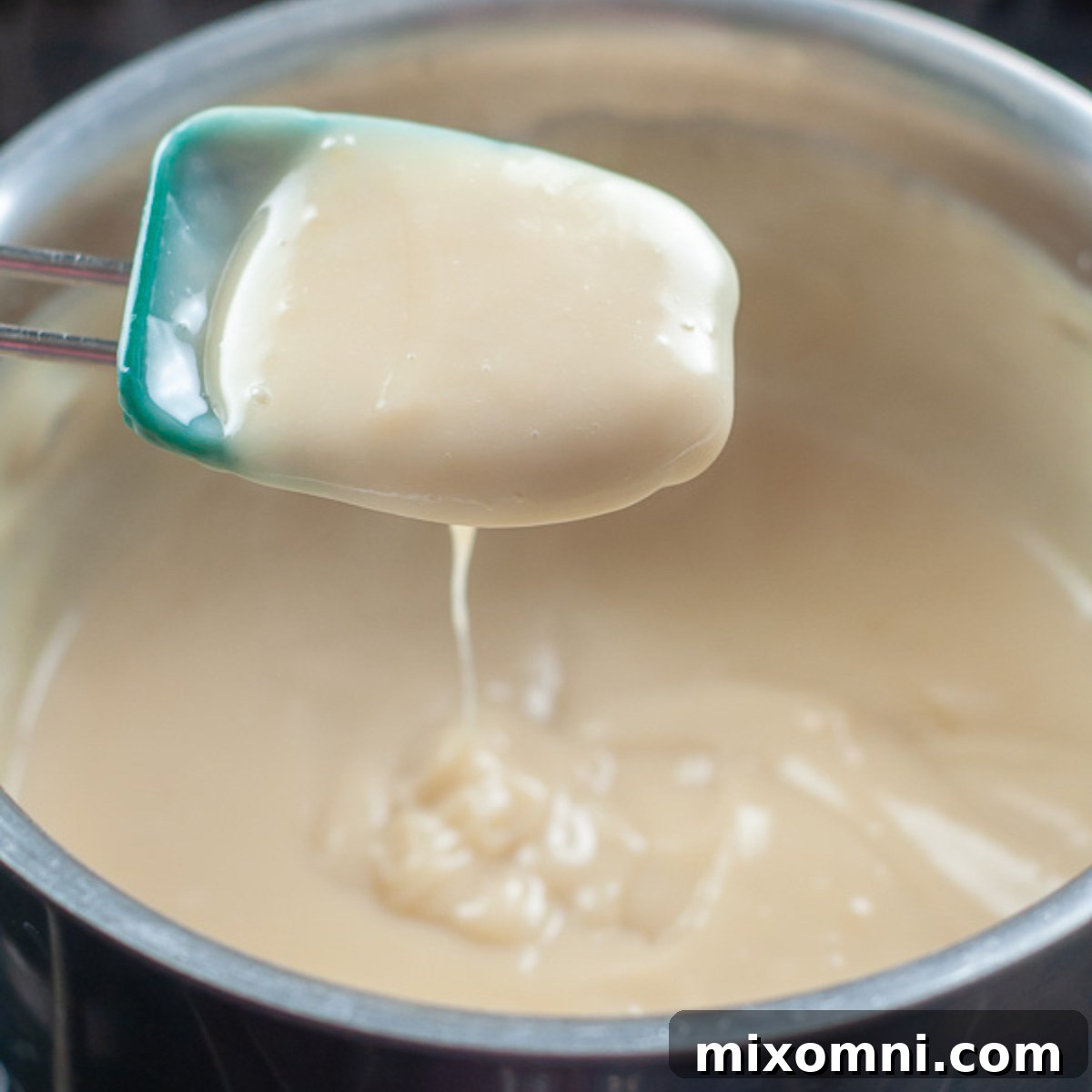 a spoon showing the thickness of the custard.