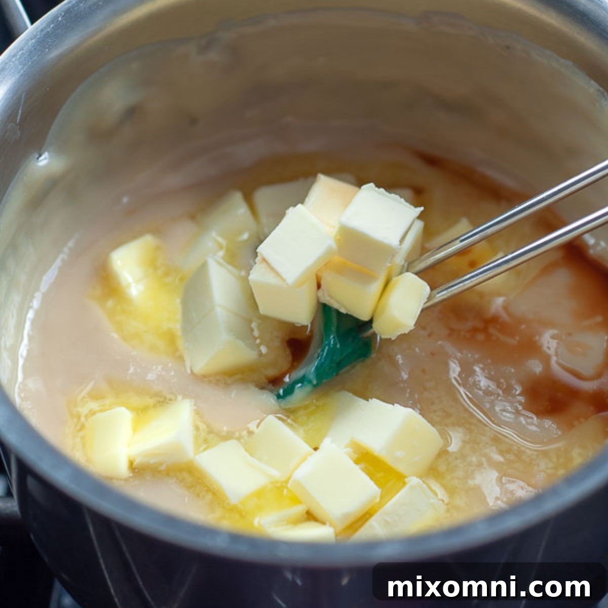 butter and vanilla being stirred into the milk mixture.