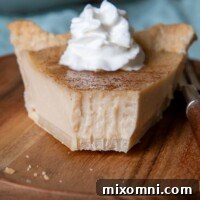 a close up of a slice of indiana sugar cream pie with a bite taken out on a plate