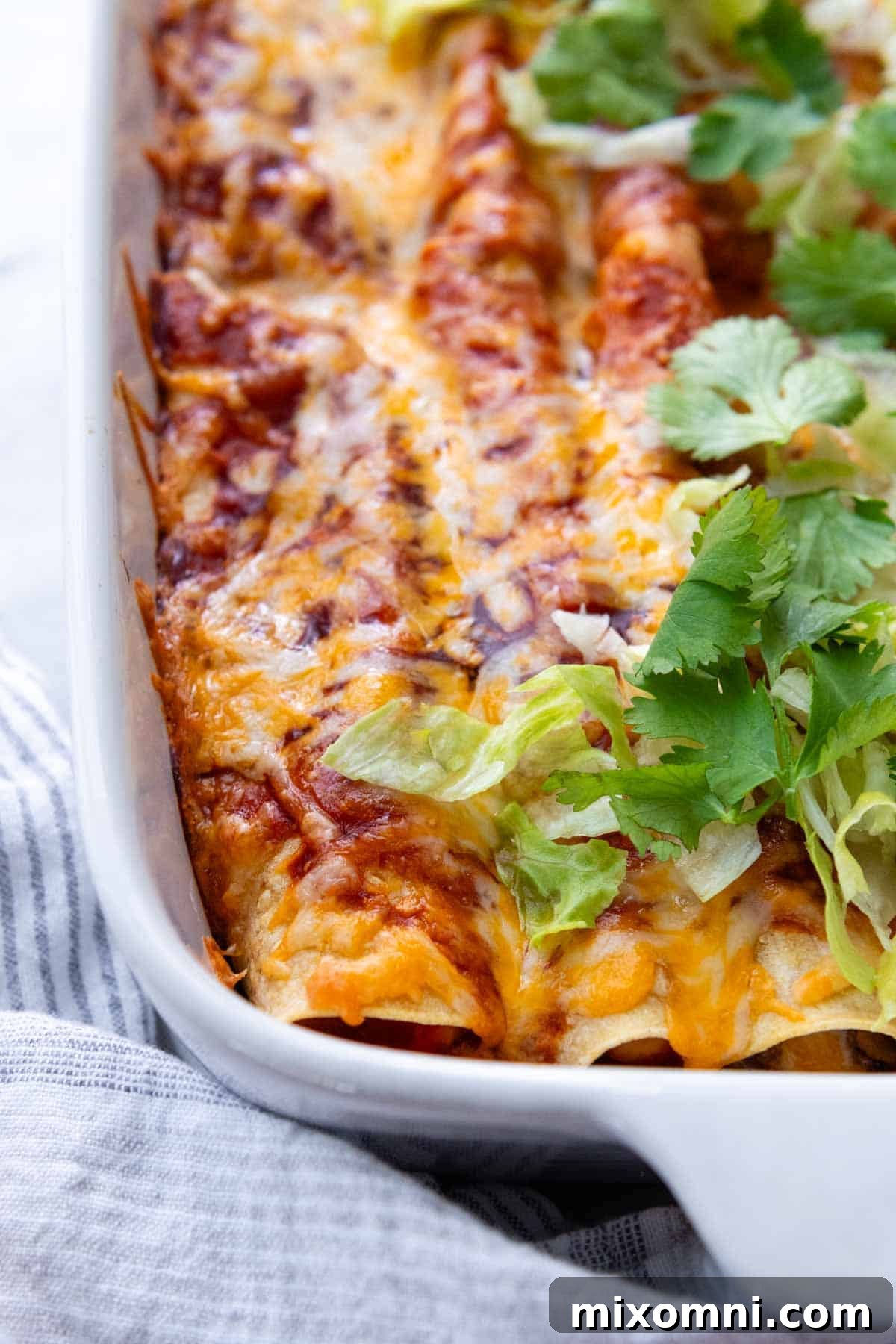 enchilada casserole with lettuce and cilantro on top.