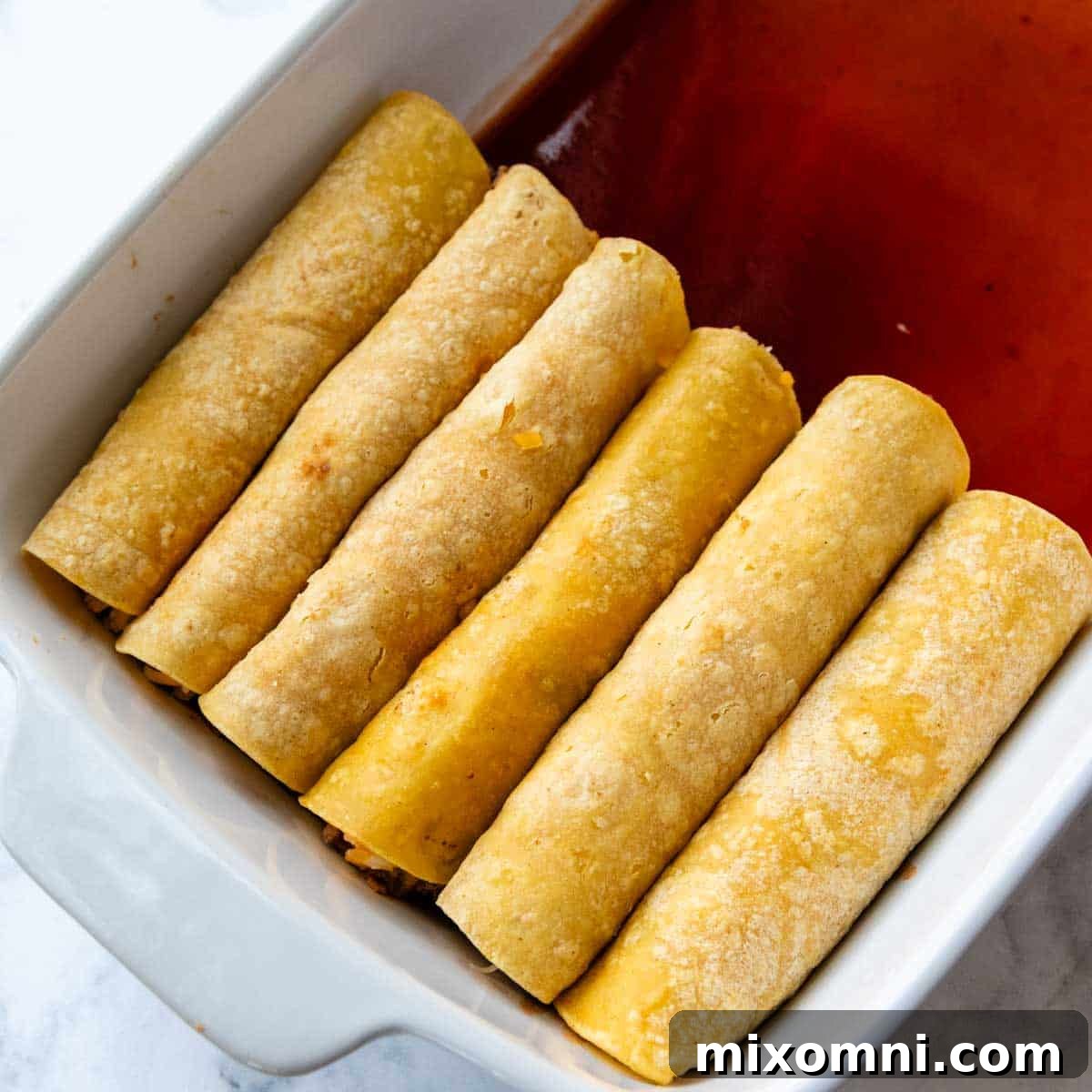 rolled enchiladas in a baking dish.