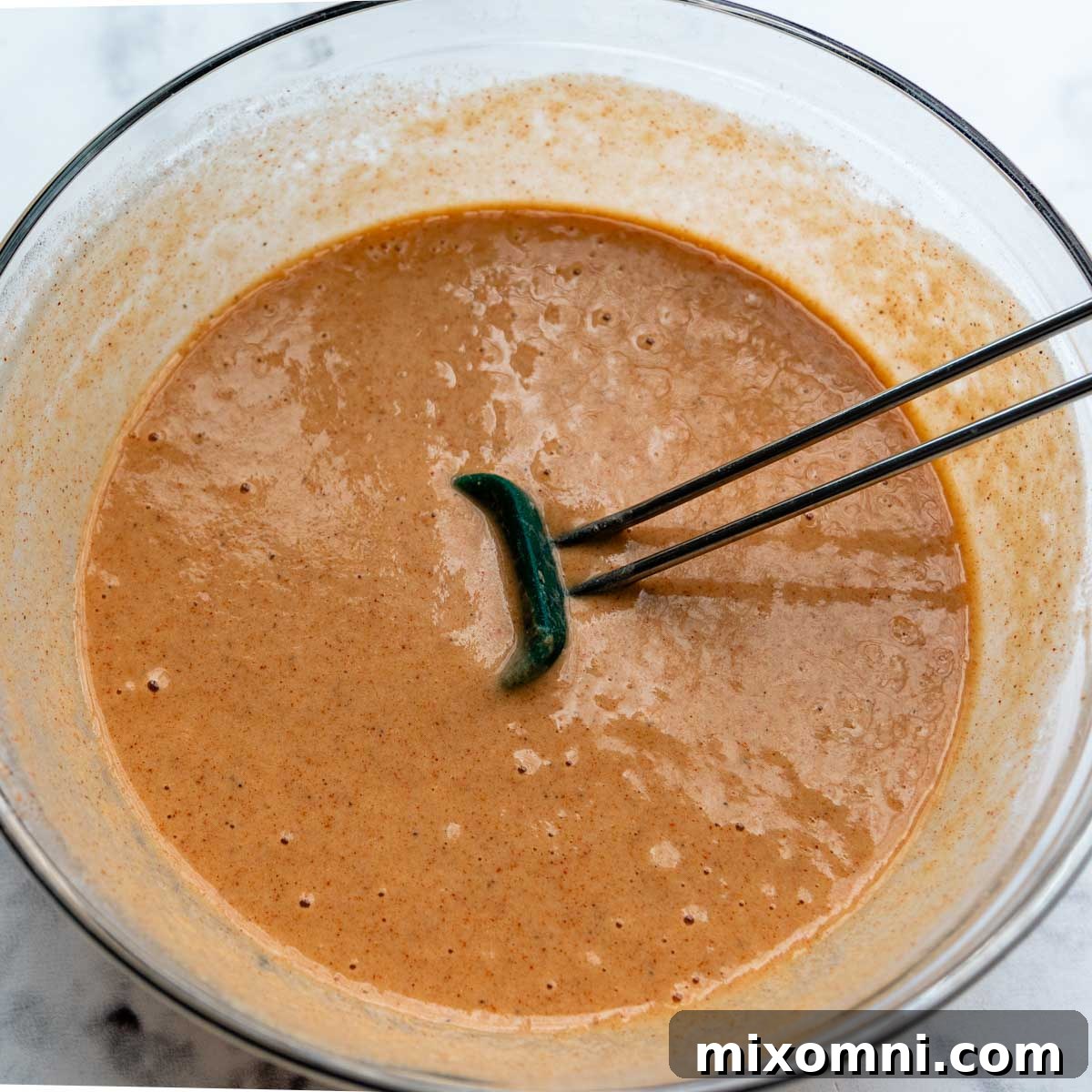 The perfectly mixed gluten-free fish batter, showing a smooth and slightly thin consistency, ready for dipping and frying.
